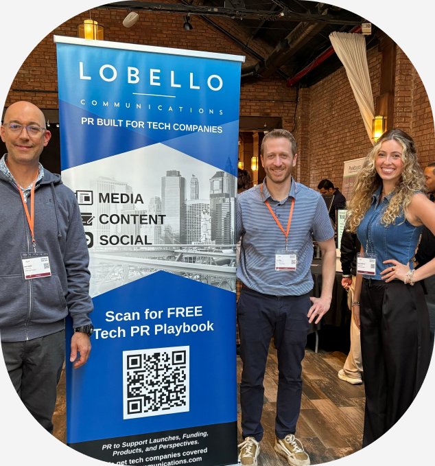 Three LoBello Communications team members at their booth during an industry event